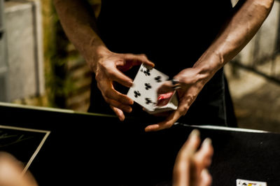 Midsection of man gambling at table