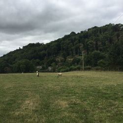 Scenic view of landscape against cloudy sky