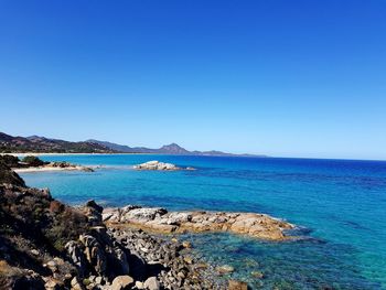 Scenic view of sea against clear blue sky