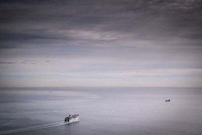 Boat sailing in sea against sky