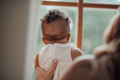 Rear view of father and son at home