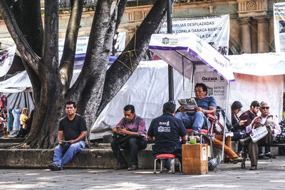 Group of people sitting in front of building