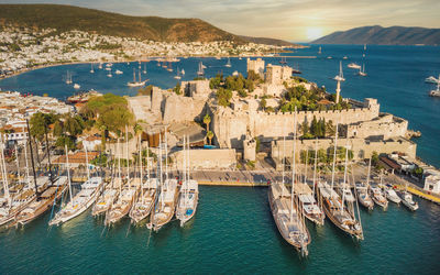 Sunset in yacht port at castle. yachting sunset scene. yachts in sunset bay. castle st. peter bodrum