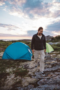 Man walking in a campsite smiling