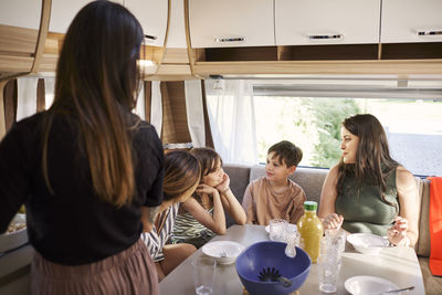 Family having meal in camper van