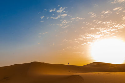 Scenic view of desert against sky during sunset