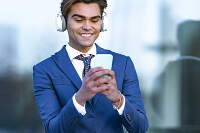 Portrait of a smiling young man standing outdoors