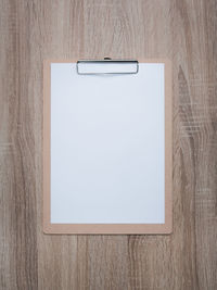 High angle view of paper on table against wall