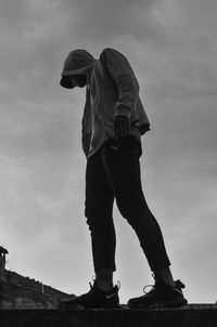 Low angle view of man standing against sky