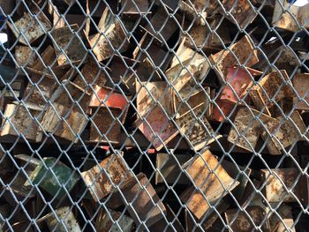 Full frame shot of rusty metals seen through chainlink fence