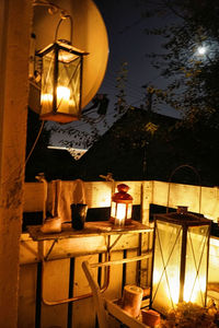 Illuminated lantern hanging on table