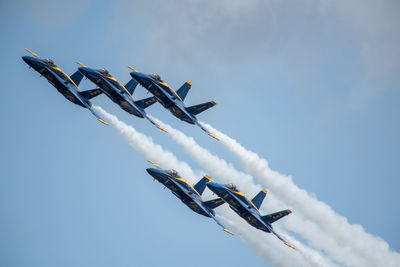 Low angle view of airplane flying against sky