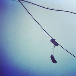 Low angle view of cables against blue sky