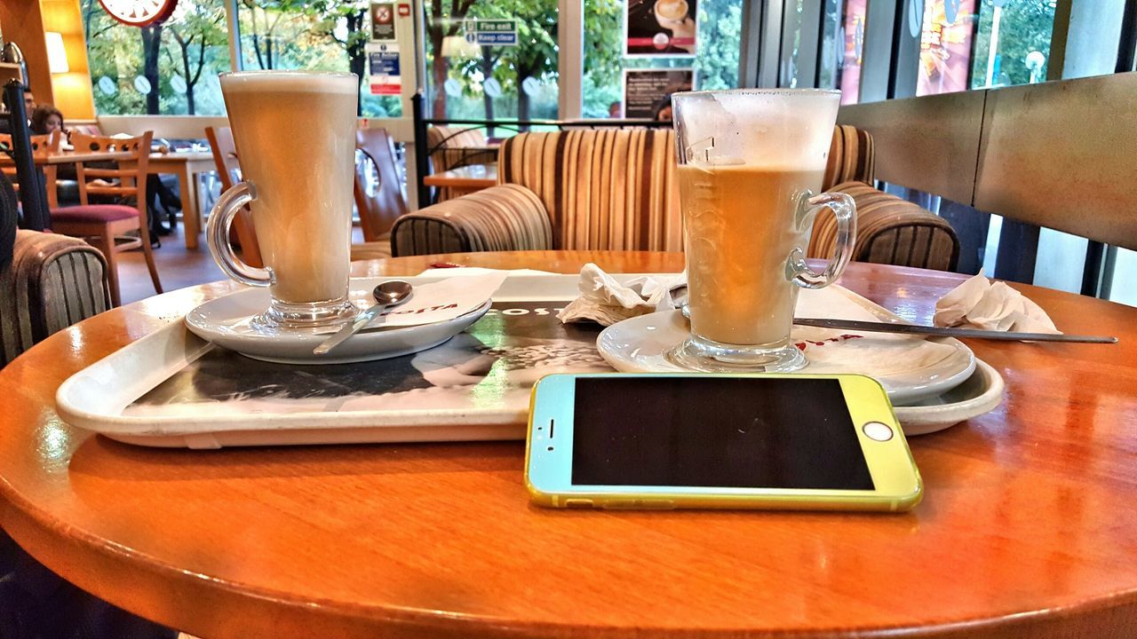 table, indoors, chair, drink, still life, restaurant, food and drink, coffee cup, wood - material, refreshment, high angle view, cafe, coffee - drink, no people, absence, home interior, dining table, close-up, technology, drinking glass