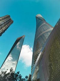 Low angle view of modern buildings against blue sky