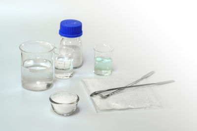 Close-up of glasses on table against white background
