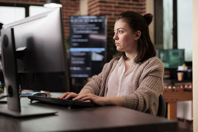 Businesswoman using laptop at table