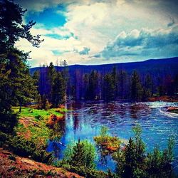 Scenic view of lake against cloudy sky