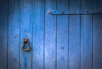 Old wooden doors with an old metal door handle knocker in brazil