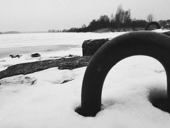 Close-up of snow on sea against clear sky