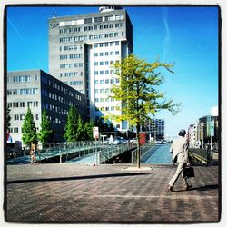 Buildings in city against blue sky