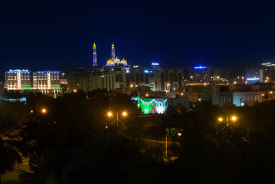 High angle view of buildings lit up at night