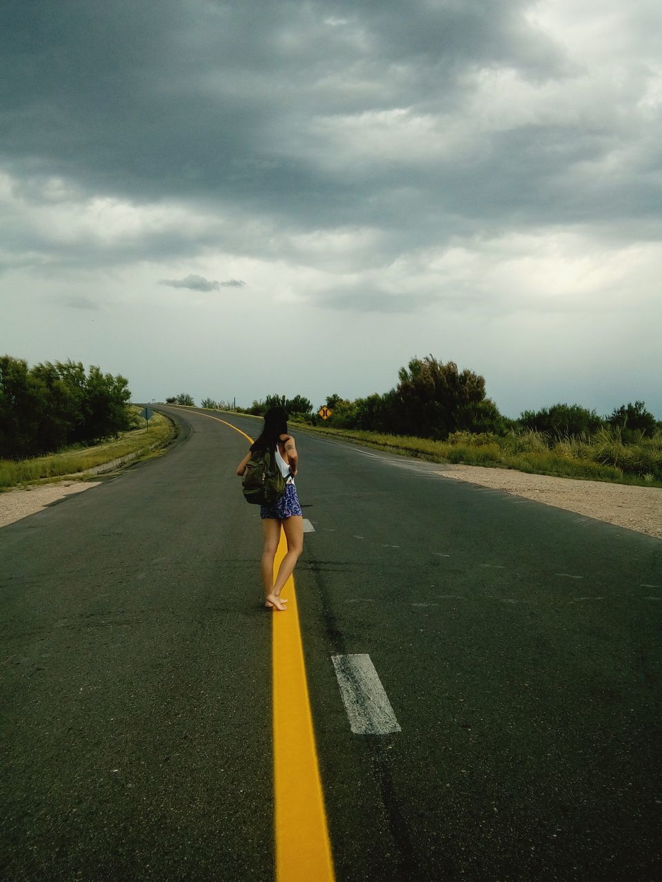 WOMAN WITH UMBRELLA ON ROAD
