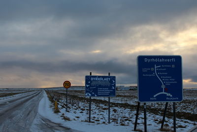 Road sign on snow covered landscape