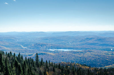 Scenic view of mountains against blue sky