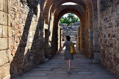 Rear view of woman walking on footpath