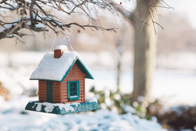 Feeding birdhouse covered by snow during winter
