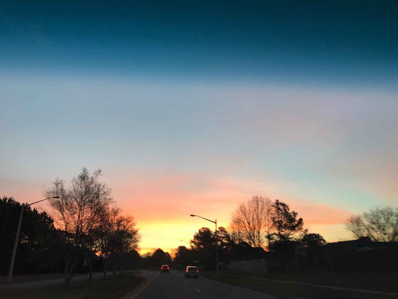ROAD AGAINST SKY AT SUNSET