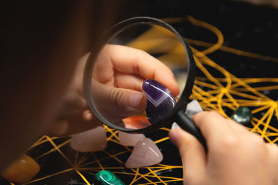 Cropped hand of person holding crystal ball