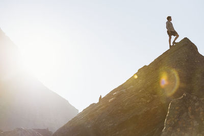 Boy on top of mountain