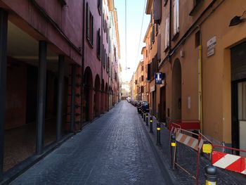 Empty narrow alley along buildings