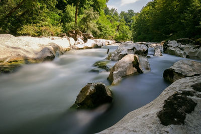 Stream flowing through rocks in river
