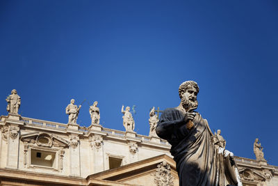 Low angle view of statue against blue sky