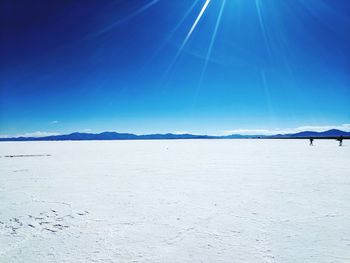 Scenic view of snowcapped mountains against clear blue sky