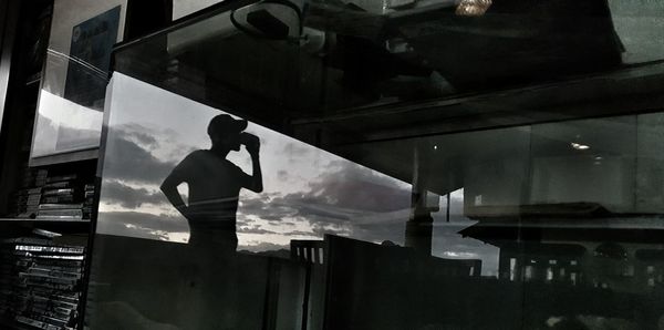 Reflection of silhouette man in television