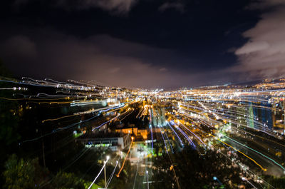 High angle view of illuminated cityscape against sky at night