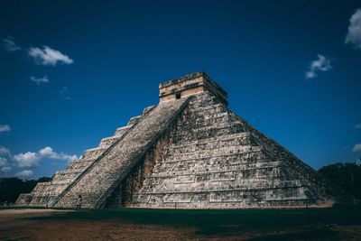 Low angle view of old temple against blue sky