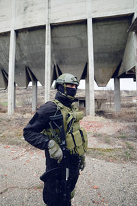 Army soldier standing against built structure