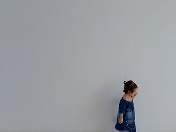 Full length of child standing against wall