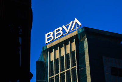 Low angle view of building against clear blue sky