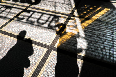 Shadow of people on tiled floor