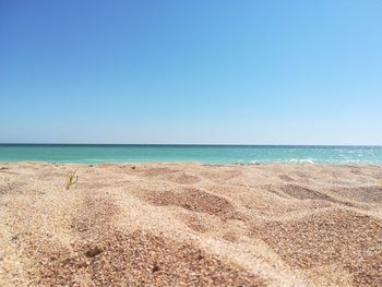 Scenic view of beach against clear blue sky