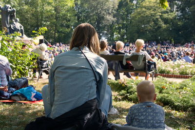 Rear view of people sitting outdoors