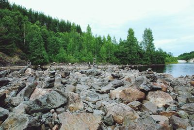 Scenic view of rocks in river against sky