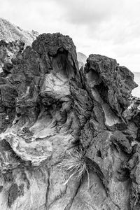 Close-up of rock formation against sky