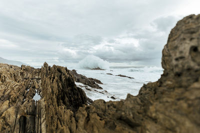 Panoramic view of rocks on beach against sky